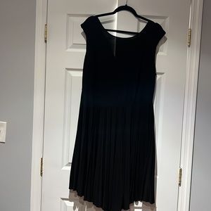 Simple black plus size swing dress mid length with pleated bottom